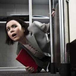 Young businesswoman overcome by fear in an office.